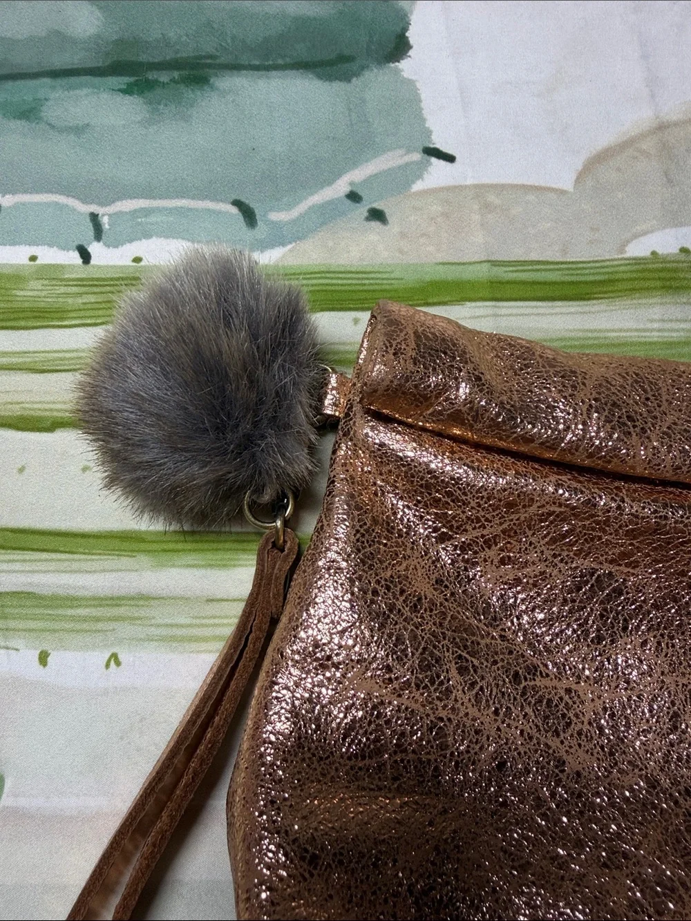 Miss Albright Metallic Rose Gold Wristlet Clutch with Pom Pom Accent